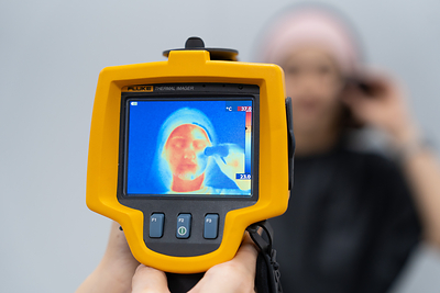 A Kolmar Korea researcher applies a cooling sun stick to one side of the face to observe differences in skin temperature.
