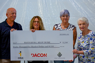 indus President Rich Goodick cross presenting donation check to Hannah B.G. Shaw Board Members