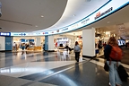 Travelers pass beneath a Watchfire indoor LED display promoting shopping options in PHL’s B/C Connector. Content can be updated in real time using Watchfire Ignite OPx.