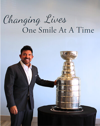 Dr. Michael Riccobene, founder and CEO of Riccobene Associates Family Dentistry, poses with the Stanley Cup during its visit to their Garner office.