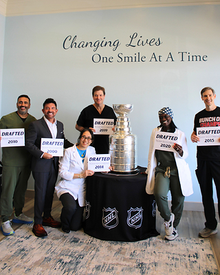 Riccobene Associates Family Dentistry team members pose with the Stanley Cup while showcasing the years they joined Team Riccobene, reflecting the organization's growth and commitment to its people.