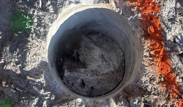 Figure 2: (TOP) Cored drill hole (~30 cm diameter) in pollucite pegmatite outcrop; (BOTTOM) Grid of cored drill holes (~30 cm diameter) in pollucite pegmatite outcrop (see Table 1). Segments between holes are jackhammered out and added to sample composite.