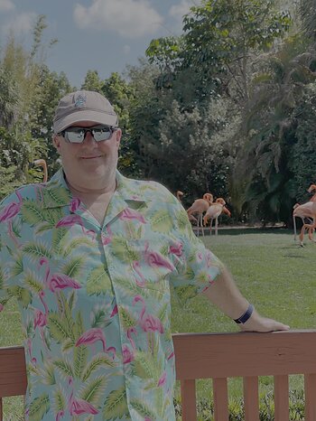 David Morrill posing with the vestibular disorder mascot, Flamingos