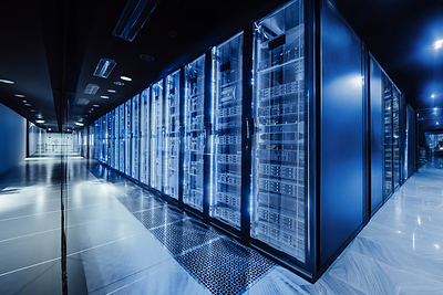 Rows of illuminated server racks inside a modern data center.