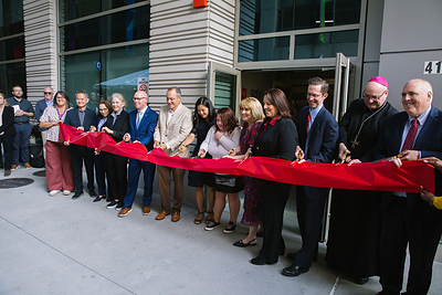 Lieutenant Governor Kim Driscoll, Mayor Michelle Wu, Archbishop Richard Henning, Rep. Aaron Michlewitz, Rep. Richard Haggerty, Councilor Ed Flynn, Boston Chief of Housing Sheila Dillon join St. Francis House President and CEO Karen LaFrazia and Planning Office of Urban Affairs President Bill Grogan cutting the ribbon at 41 LaGrange Street.