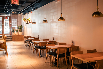 Inside Little Pine, a Dongbei Chinese restaurant and bar on Manhattan's Lower East Side, warm materials and modern design create an intimate setting for the regional cuisine of Northeast China.