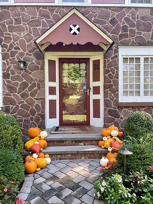 A small smattering of pumpkins on the front steps of a NJ home