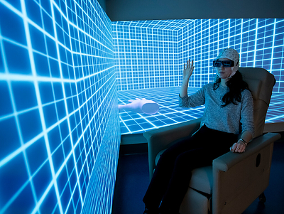 A participant wears an EEG cap inside the Mass General Data Visualization Room, illustrating how immersive stimulus presentation can be integrated with physiological measurement. A participant wears an EEG cap inside the Mass General Data Visualization Room, illustrating how immersive stimulus presentation can be integrated with physiological measurement.