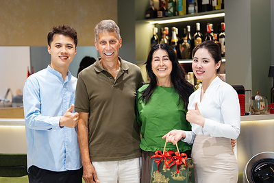 International patients with Greenfield Dental care team in the clinic lounge