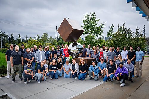 TextNow's Waterloo, CA-based employees pictured alongside 'Équilibre Oblique," a permanent public sculpture by Canadian artist Philippe Pallafray in Waterloo's Research and Technology Park.