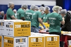 CGI employees packaging meals at the 9/11 Day meal pack event at the Portland Expo Center