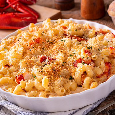 One option is to keep things simple with one make-ahead showstopper, such as Lobster Mac & Cheese.  It can be assembled fully in advance; baked as guests arrive; then served oven-to-table. Gemma di Luna Prosecco provides a sparkling counterpoint, with its fresh acidity balancing the rich cheese sauce.