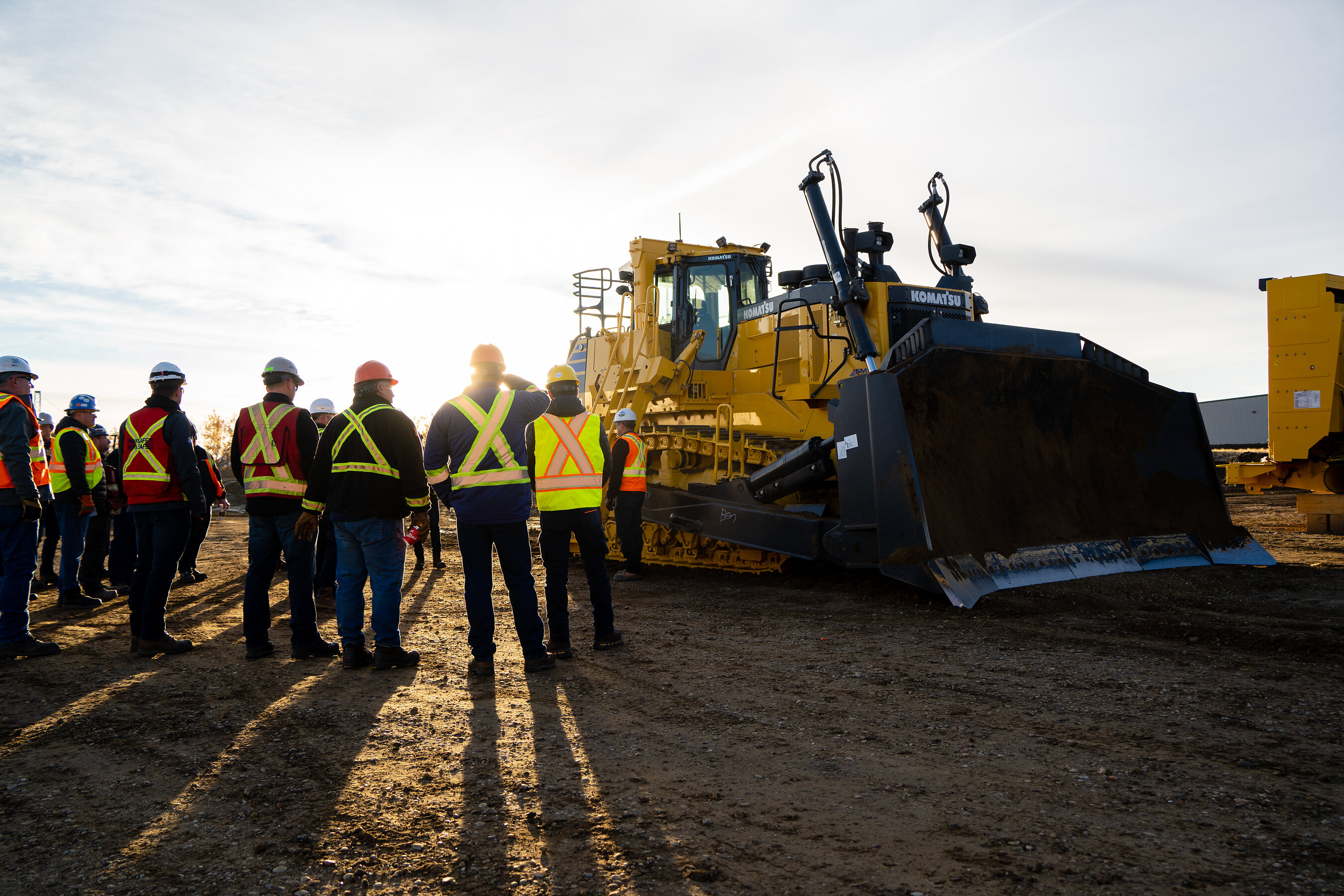 SMS Equipment customers and employees gather around a Komatsu mining dozer demonstration.