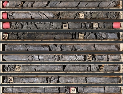 Photo 1: An interval of pink facies and massive sulphide mineralization in TS26-003 consisting of laminated to massive sphalerite, galena, and barite from 1,021.4 to 1,031.4 m