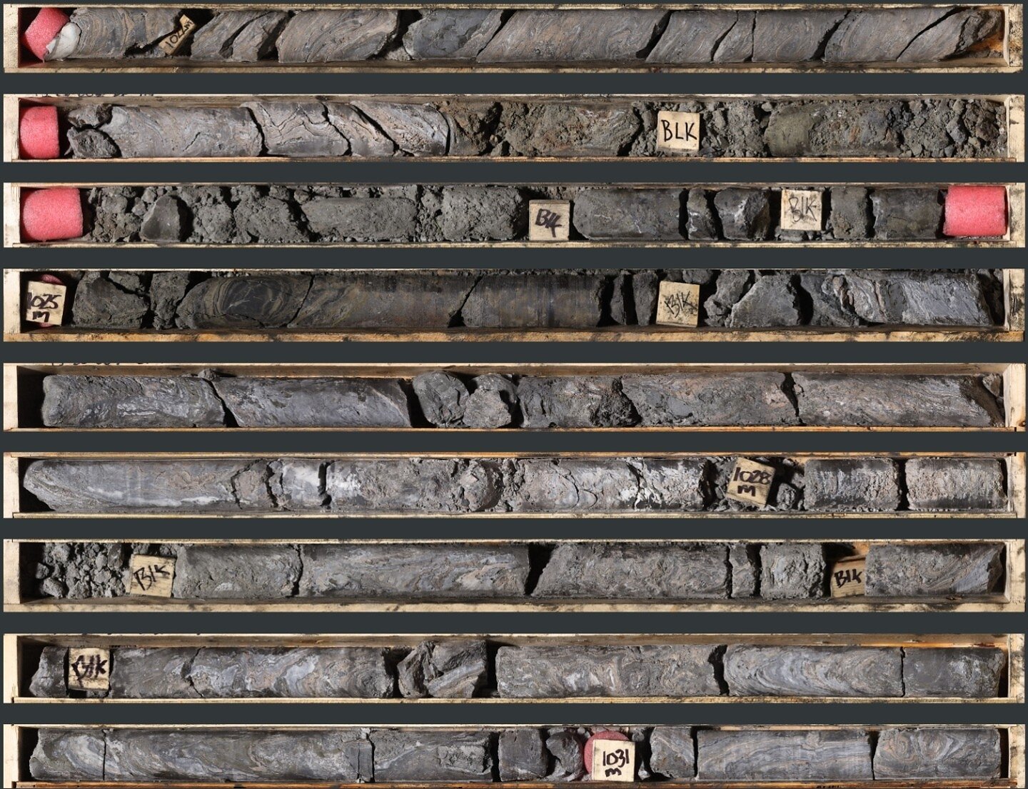 Photo 1: An interval of pink facies and massive sulphide mineralization in TS26-003 consisting of laminated to massive sphalerite, galena, and barite from 1,021.4 to 1,031.4 m