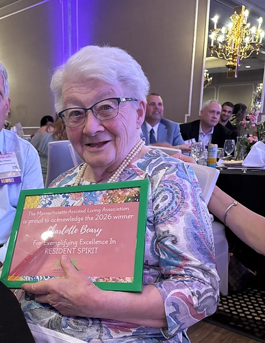 Charlotte Beary, resident at The Village at Willow Crossings, accepts the Mass-ALA Resident Spirit Award