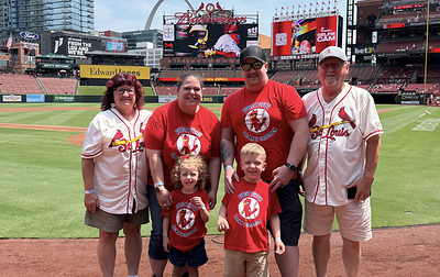 Four-year-old Ollie with his family at Busch Stadium, where he threw out a ceremonial first pitch during a St. Louis Cardinals game as part of Brown & Crouppen’s partnership with Rainbows for Kids, creating a special ballpark experience for Ollie and his loved ones.