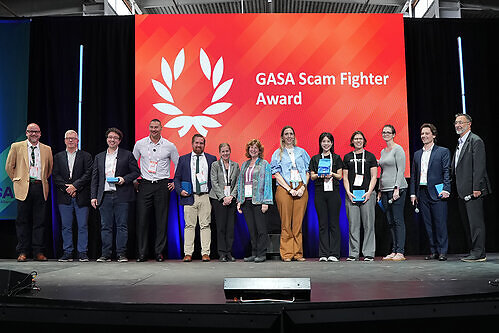 ScamAdviser Head of Growth, Yuying Shih (fifth from the right), receives the Scam Fighter Award for Watchmen at GASS America 2026 This image opens in the lightbox