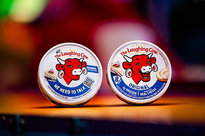 The Laughing Cow® original packaging alongside The Not Laughing Cow, which appears on select packages of The Laughing Cow® Creamy Original cheese wedges nationwide.