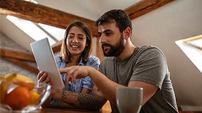 Couple looking at tablet.
