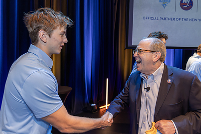 New York Islanders Co-Owner Jon Ledecky shakes hands with a member of the LIU men’s hockey team during Long Island University’s CEO Speaker Series.