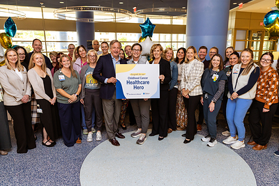 Steve Radke, president of the Northwestern Mutual Foundation, presents the inaugural Northwestern Mutual Childhood Cancer Healthcare Hero Award to Katy Tomlinson, RN, BSN, joined by Kim Stapelfeldt, executive director of Children's Wisconsin MACC Fund Center for Cancer and Blood Disorders. The award recognizes exceptional dedication to supporting children and families affected by childhood cancer (courtesy of Northwestern Mutual).