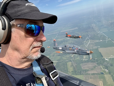 Founder Dean Siracusa flying formation in a TB30 Epsilon, with a second Epsilon and an SF260 off the wing, wearing the new Kingfisher Sport under a Lightspeed Zulu 3. The 1mm Resilamide™ temples disappear under the ear seals, so there is nothing to think about but the airplane next to you. The taller lens keeps the top and bottom of the frame out of your line of sight. Translucent gray with gradient mirrored sapphire. Founder Dean Siracusa flying formation in a TB30 Epsilon, with a second Epsilon and an SF260 off the wing, wearing the new Kingfisher Sport under a Lightspeed Zulu 3. The 1mm Resilamide™ temples disappear under the ear seals, so there is nothing to think about but the airplane next to you. The taller lens keeps the top and bottom of the frame out of your line of sight. Translucent gray with gradient mirrored sapphire.