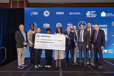 The LeFrak and Simon families present a $100,000 grant to the Anti-Violence Coalition of Hudson County as part of the partnership's $2 million commitment to 40 Jersey City nonprofits, celebrating Newport’s 40th anniversary. 