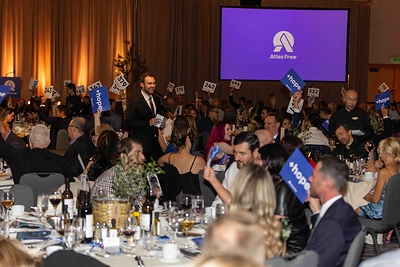 Guests raise their bid cards to donate and contribute to the $1.6 million raised at Atlas Free's most successful gala to date.