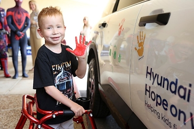 A child places his handprint on a Hyundai vehicle at a Handprint Ceremony at St. Joseph's Children's Hospital in Tampa, Fla. on July 14, 2026. (Photo/Hyundai)