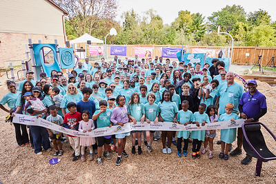 The kids holding the ribbon helped design the playground behind them. Maple Glen families, Foresters Financial employee volunteers and KABOOM! gathered to open it in Oshawa on Sept. 26, 2026.