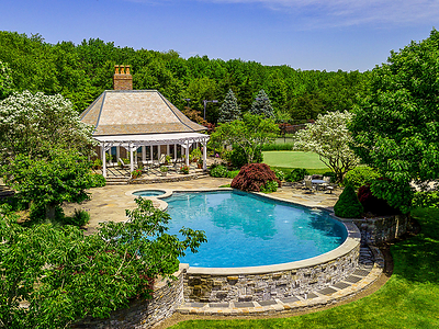 Just off the custom, 50,000-gallon pool is the large pool house. The 1,088-sf structure includes lofted ceilings with exposed wood beams, a fireplace, kitchenette and one (1) full bath. NewJerseyLuxuryAuction.com. Just off the custom, 50,000-gallon pool is the large pool house. The 1,088-sf structure includes lofted ceilings with exposed wood beams, a fireplace, kitchenette and one (1) full bath. NewJerseyLuxuryAuction.com.