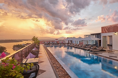 The Art Nouveau-inspired rooftop pool overlooking the Thu Bon River at Hotel Royal Hoi An – The Legacy By The River.
