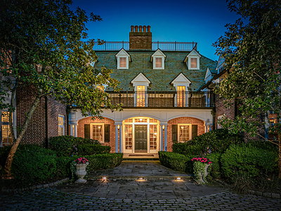 The entrance to the main residence exudes a warm, welcoming glow in the evening. The home has a circular courtyard arrival and an adjacent, 4-vehicle garage with carport. NewJerseyLuxuryAuction.com. The entrance to the main residence exudes a warm, welcoming glow in the evening. The home has a circular courtyard arrival and an adjacent, 4-vehicle garage with carport. NewJerseyLuxuryAuction.com.