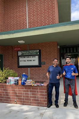 Christian Akhoian of Rooter Hero delivers school supplies to Dahlia Heights Elementary School. 