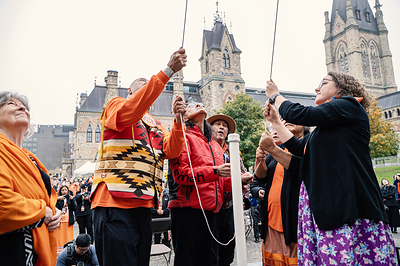 Her Excellency the Right Honourable Louise Arbour, Governor General of Canada, witnesses Survivors Eugene Arcand, Bernard Andreason, Dr. Antoine Mountain, Ann Lafleur, and Jeanette Wawatie, joined by Minister Alty, raise the new Survivors’ Flag. Her Excellency the Right Honourable Louise Arbour, Governor General of Canada, witnesses Survivors Eugene Arcand, Bernard Andreason, Dr. Antoine Mountain, Ann Lafleur, and Jeanette Wawatie, joined by Minister Alty, raise the new Survivors’ Flag.