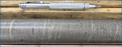 Figure 4: Close-up Photograph of the massive sulphides with chalcopyrite concentrated in1 to 3 mm bands. Center of photograph is at 159.7 meters in hole CUP26-010. The small black spots in the massive sulphides are magnetite; the pyrrhotite is not magnetic.