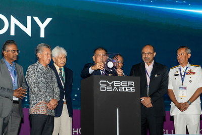 YB Datuk Wilson Ugak Anak Kumbong, Deputy Minister of Digital Malaysia (middle), officially opens CyberDSA 2026 at the Malaysia International Trade and Exhibition Centre (MITEC), Kuala Lumpur, on 5 October 2026. The Deputy Minister is accompanied by Encik Ma. Sivanesan, Deputy Secretary General (Digital Development), Ministry of Digital, Dato’ Shaharuddin bin Abu Sohot, Secretary General, Ministry of Tourism, Arts and Culture Malaysia, Tan Sri Asmat Kamaludin, Chairman of Aerosea Exhibitions Sdn Bhd, Dato’ Sri Noor Hisam bin Nordin, Director of Crime Prevention and Community Safety Department of the Royal Malaysia Police, Encik Shakib Ahmad Shakir Jamaludin, Deputy Secretary General (Strategic & Management), Ministry of Digital, and Rear Admiral Dato' Fadhil bin Abdul Rahman, Commander, Defence Cyber and Electromagnetic Command, Malaysian Armed Forces.