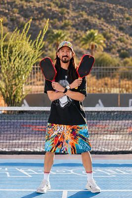 Steve Aoki shows off the Hiro and Hyro colorways of the limited-edition JOOLA x Steve Aoki HiROQUEST Perseus Pro V 16mm pickleball paddles. The collection, which also includes two Infinity Carbon table tennis rackets, drops October 6, 2026, exclusively at JOOLA.com Steve Aoki shows off the Hiro and Hyro colorways of the limited-edition JOOLA x Steve Aoki HiROQUEST Perseus Pro V 16mm pickleball paddles. The collection, which also includes two Infinity Carbon table tennis rackets, drops October 6, 2026, exclusively at JOOLA.com