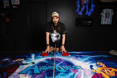 Steve Aoki with the limited-edition JOOLA x Steve Aoki HiROQUEST Infinity Carbon table tennis rackets, available October 6, 2026, exclusively at JOOLA.com. Steve Aoki with the limited-edition JOOLA x Steve Aoki HiROQUEST Infinity Carbon table tennis rackets, available October 6, 2026, exclusively at JOOLA.com.