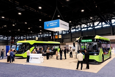 Visitors explore the electric buses at the VinFast booth.