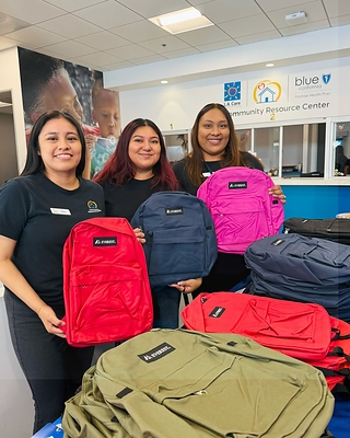 Blue Shield Promise and L.A. Care connect families and students with backpacks filled with school supplies.