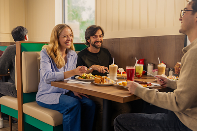 A scene from Stacked's new evergreen campaign, Life Happens Around the Table, which shows friends gathering for breakfast.