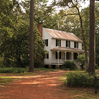 A historical Carolina home with aged metal roofing.