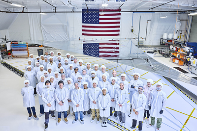 Reflect Orbital team in front of mirror prototype. 