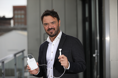 Neuromod Founder and CEO, Dr. Ross O’Neill Ph. D. holding the Lenire bimodal neuromodulation tinnitus treatment device. Neuromod Founder and CEO, Dr. Ross O’Neill Ph. D. holding the Lenire bimodal neuromodulation tinnitus treatment device.