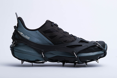 Garibaldi 11 carries eleven 9/16-inch spikes under each foot, held by a heat-moulded elastomer harness that goes on over most footwear in about ten seconds. The name comes from Garibaldi Provincial Park in the Coast Mountains north of Vancouver, where founder C.S. Kang was hiking when he started the company.
