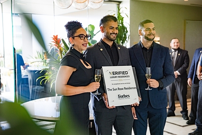 The FirstService Residential team celebrating that The Sun Rose Residences has received the Forbes Travel Guide VERIFIED™ Luxury Residences designation The FirstService Residential team celebrating that The Sun Rose Residences has received the Forbes Travel Guide VERIFIED™ Luxury Residences designation