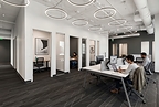 Open workspace and private offices at e|spaces Orlando, with professionals working at shared desks.
