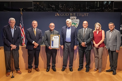 Members of the San Bernardino County Board of Supervisors present a proclamation for ONT Day to airport CEO Atif Elkadi (center, left) and OIAA Commission President Dr. Ronald Loveridge (center, right).